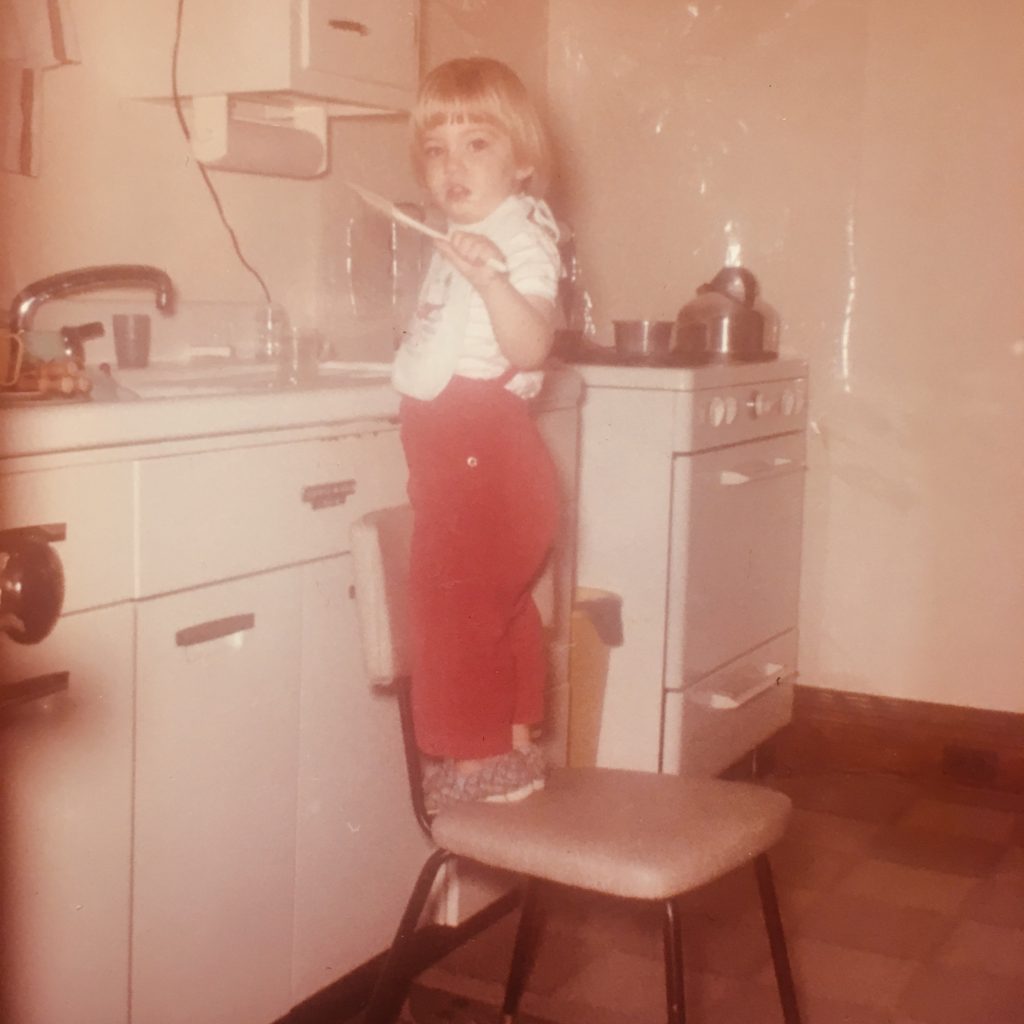 Patti at the sink in her childhood home, that was salvaged and used in the cabin.